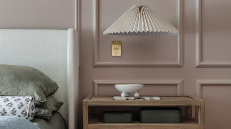 boutique hotel vibes moody master bedroom picture molding pleated hanging lights featured in Rue Magazine