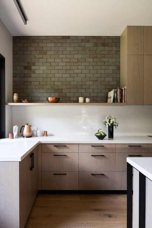 mix of upper cabinets and single floating shelf plus green brick tile