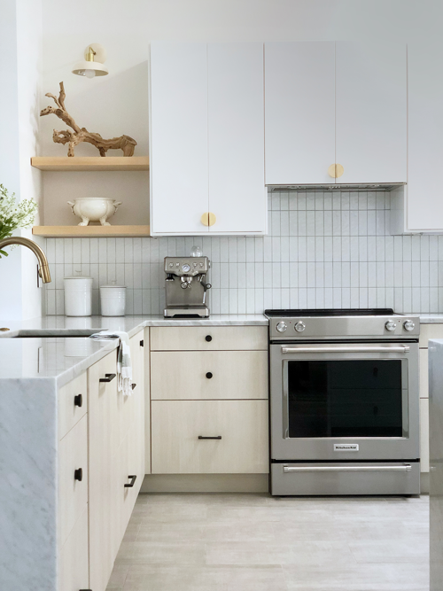 beach modern kitchen with upper cabinets and maple floating shelves