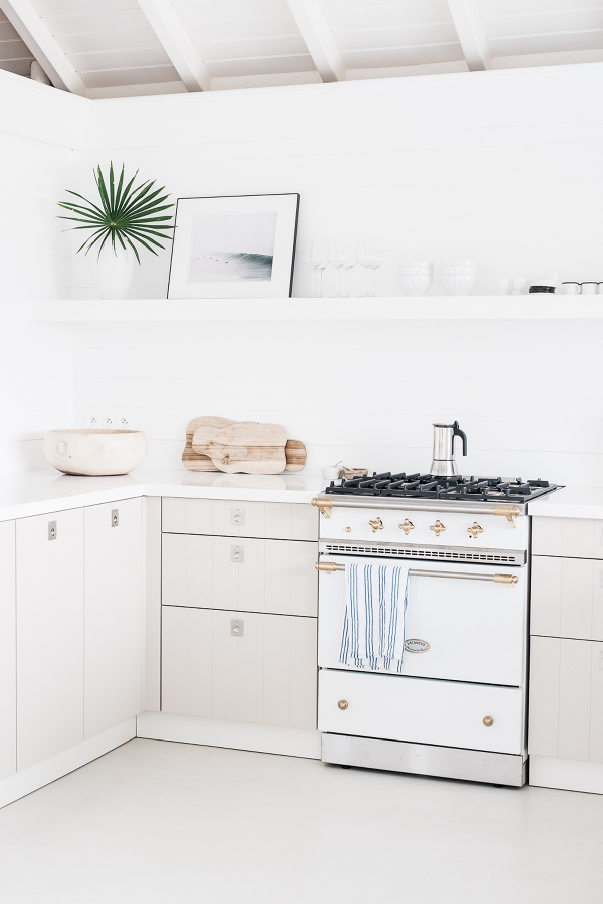 bright minimal fresh kitchen with single floating shelf