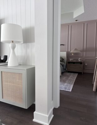 view into primary bedroom from living room showing contrast of paint colors