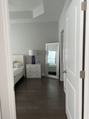 before image of primary bedroom with builder grade finishes